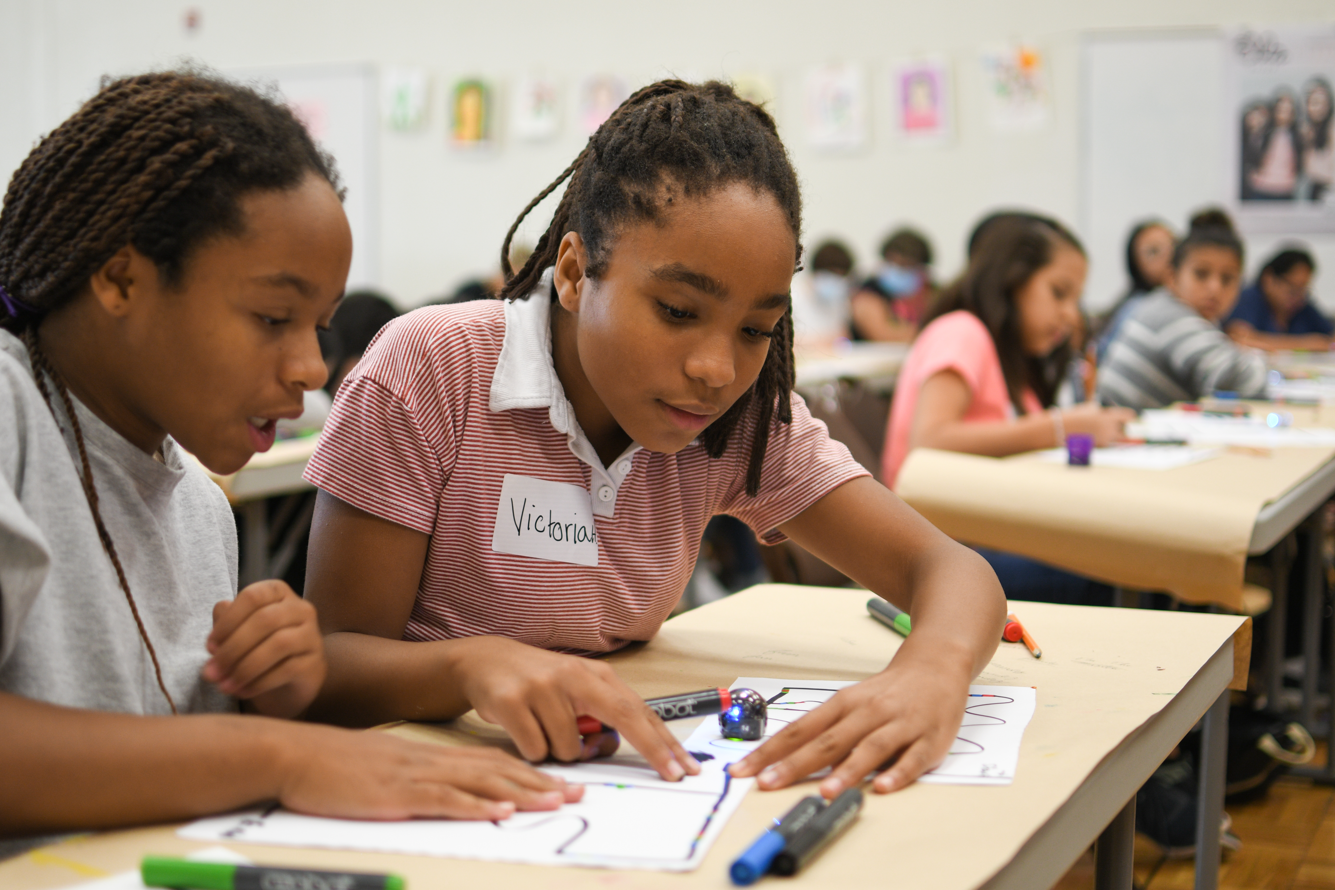 Instructor helping a student with classwork in a supportive learning environment